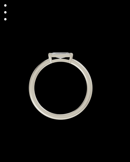 Silver ring with a bow design on a black background