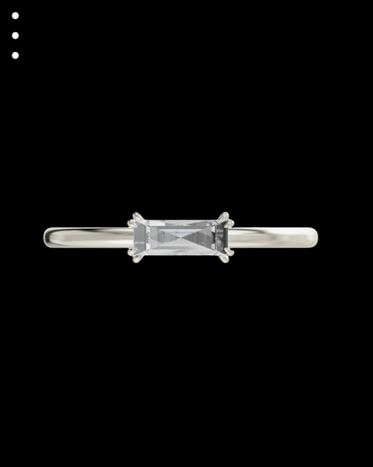 Silver ring with a rectangular gemstone on a black background