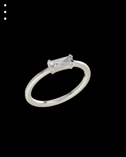Silver ring with a rectangular diamond on a black background