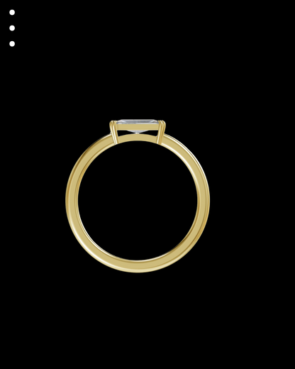 Gold ring with a diamond on a black background