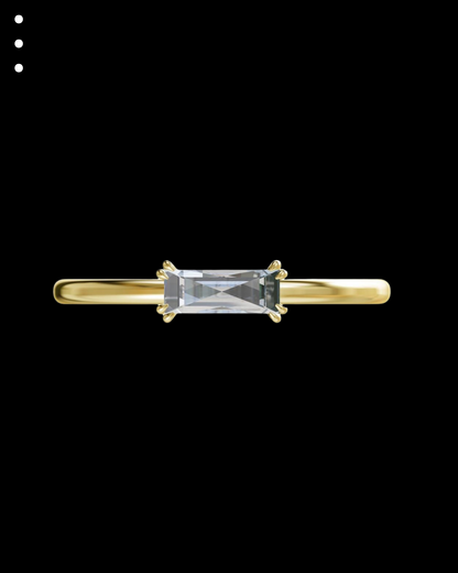 Gold ring with a rectangular gemstone on a black background