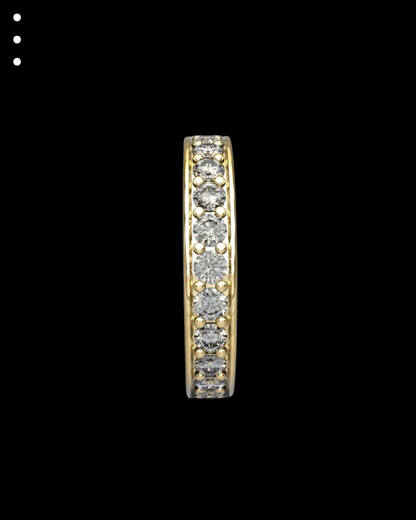 Gold ring with embedded diamonds on a black background