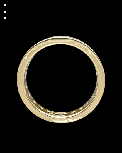 Gold ring with intricate design on a black background