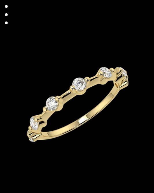 Gold ring with small diamonds on a black background